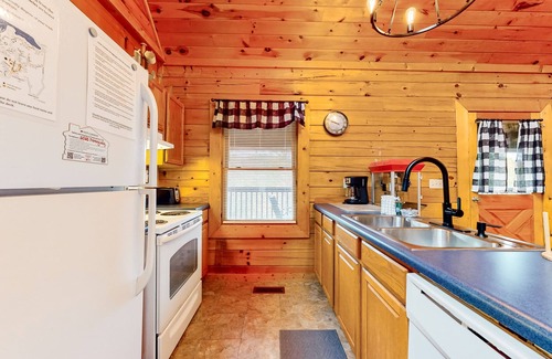 Sevierville Cabin | Forest-view cabin with pool, hot tub, fireplace, deck, & free attraction tickets