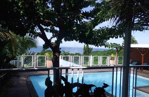 Deshaies Apartment | Fuchsia apartment in a postcard setting overlooking the Caribbean Sea