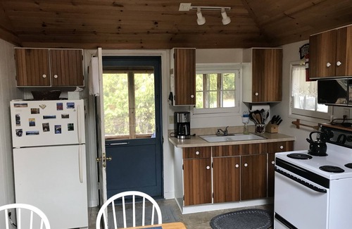 Baileys Harbor Cottage | Get away at this quaint cottage tucked behind a beautiful fern bed.