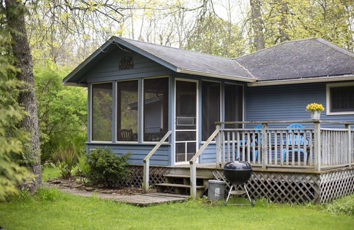 Baileys Harbor Cottage | Get away at this quaint cottage tucked behind a beautiful fern bed.
