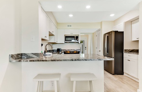 Upper Grand Lagoon Condo | Golf course-adjacent home with shuffleboard table & furnished patio