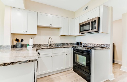 Upper Grand Lagoon Condo | Golf course-adjacent home with shuffleboard table & furnished patio