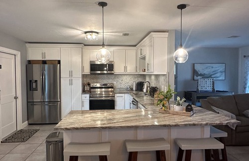 Pelican House | Gulf access pet friendly waterfront oasis with NEW heated salt water pool & spa