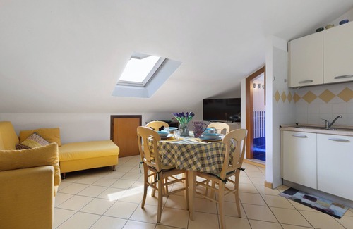 Caorle Apartment | Holiday Apartment "Mansarda Di Ponente" near Beach with Shared Garden & A/C