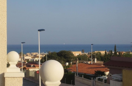 Torrevieja House | Holiday Home 'Casa de Sonrisa' with Shared Pool, Wi-Fi, Garden & Terrace