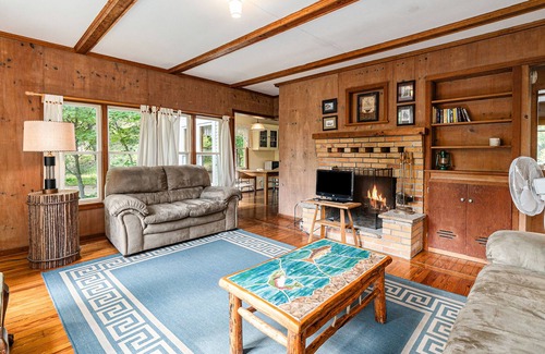 Frankfort Cottage | Homey cabin with lake access, firepit, yard games, kayaks, & basketball court