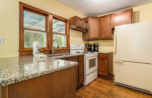 Frankfort Cottage | Homey cabin with lake access, firepit, yard games, kayaks, & basketball court