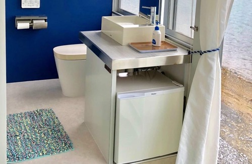 Nago Apartment | Indigo Ocean front Large windows overlook the se / Nago Okinawa