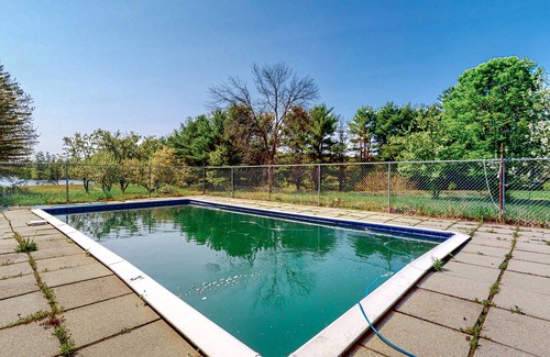 Barnstead House | Inviting riverfront home with pool, kayaks, firepit, & W/D