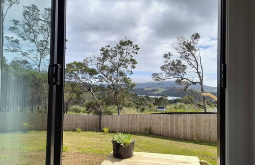 Mangonui House | Itzy Bitzy house is colourful, cosy, fully fenced with sea views