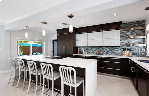 Central Fort Lauderdale House | Just 10min to downtown Ft. Lauderdale & beach, this modern home offers everything a group could want for an upscale relaxing getaway. Unwind in the very private and peaceful backyard oasis, featuring a heated ($) pool, 6-person hot tub & fire pit.