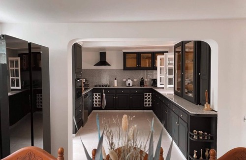 La Plaine des Cafres House | Kiki et Ginette Wood burning fireplace and kitchen