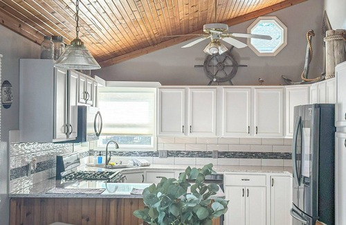 Sunrise Beach House | Lakefront 3BR, 2BA home in coveted cove near Margaritaville and Paradise. Features private dock with sundeck, decks with grill and firepit, gourmet kitchen, kayaks, WiFi, and pet-friendly fun. Quiet Cove minutes from the Action.