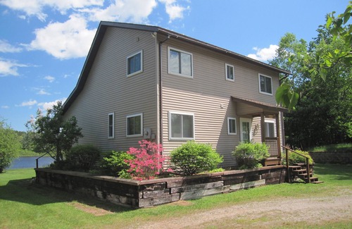 Wetmore Cottage | Lakefront, covered deck, huge backyard with grill, swimming, boat & kayaks!