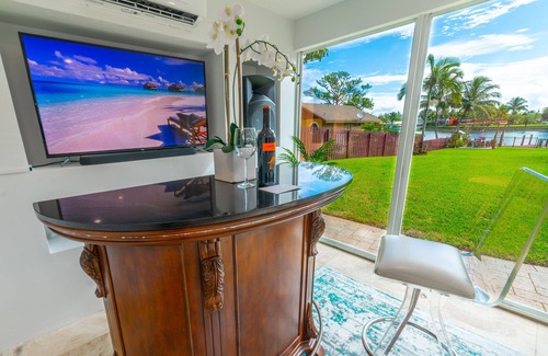 Lake Worth House | Lakefront Oasis for Gatherings - Heated Pool Tiki Huts Game Room Sleep 14