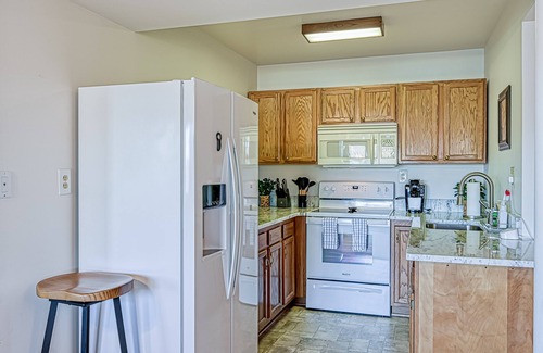 Sandy Point House | Lakefront retreat with a large yard, stone fire pit, gazebo, deck, & dock