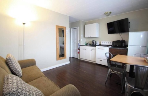 Harrison Hot Springs Cabin | lakeside bedroom and a living area with stunning views of Harrison Lakennn
