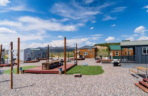 Meeker House | Lion Canyon was built by Mitchcraft in Fort Collins, Colorado as part of HGTV's "Tiny House Hunters". This home has two lofts, each with a Queen bed. One is accessible by stairs and one by ladder.