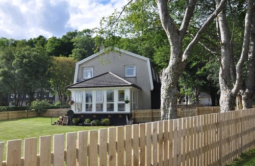 West Laroch Cottage | Lochside with beach access uninterrupted views of spectacular Highland Mountains