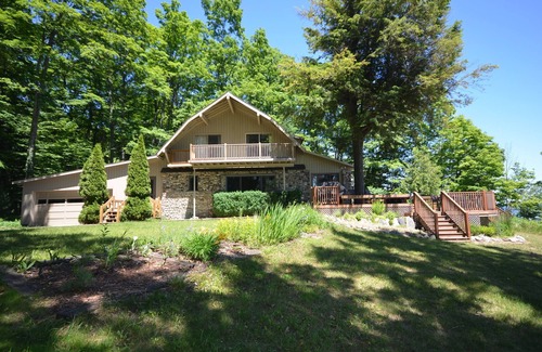 Suttons Bay House | Lodge-style home in Suttons Bay. Main house & caboose. Central A/C. Pet ok.