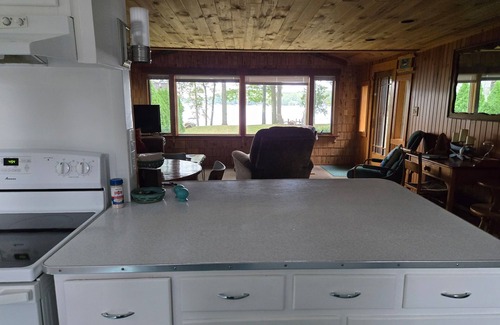 Traverse City Cottage | Long Lake Cozy Stone Cottage - Frontage - 4 Kayaks - Fire pit - Pet friendly