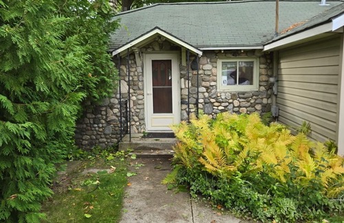 Traverse City Cottage | Long Lake Cozy Stone Cottage - Frontage - 4 Kayaks - Fire pit - Pet friendly