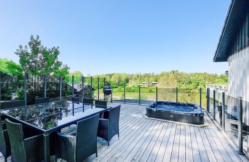 Grabo House | Look forward to sunset watching in bubbling hot tub overlooking horse pastures near lake