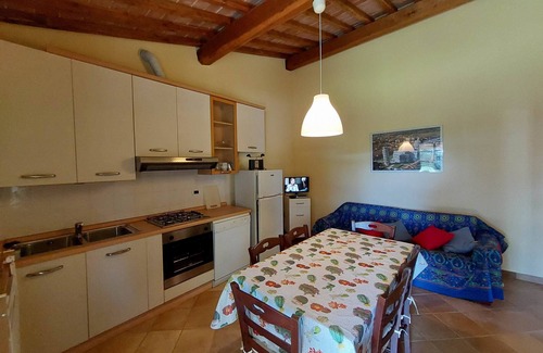 Rosignano Marittimo House | Lovely flat with private covered terrace, pool, large shared garden.