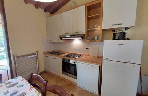 Rosignano Marittimo House | Lovely flat with private covered terrace, pool, large shared garden.