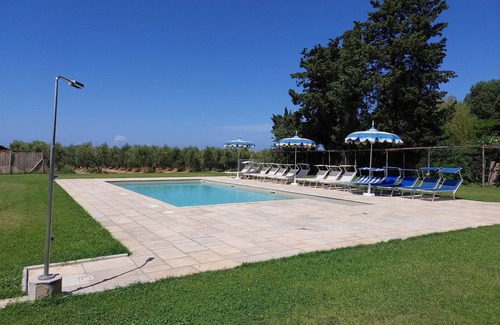 Rosignano Marittimo House | Lovely flat with private covered terrace, pool, large shared garden.