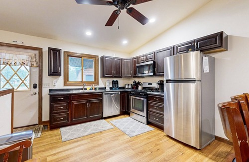 Nekoosa House | Lovely lakefront home with a game room, firepit, dock & W/D - private beach area