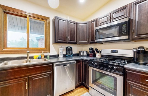 Nekoosa House | Lovely lakefront home with a game room, firepit, dock & W/D - private beach area