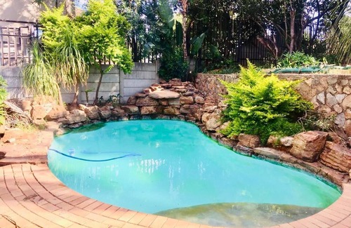 Randpark Ridge House | Lovely Studio Apartment sitting on a lovely acreage with natural man made rocks.
