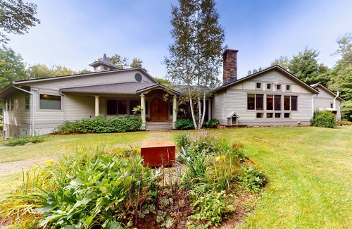 Warren House | Luxe custom home with hot tub, game room, & beautiful garden