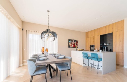 Zeewolde House | Luxury 6-person villa with private infrared sauna, outdoor shower, balcony with water views and sunny fenced garden with private dock. Located at Villa Resort Harderwold.