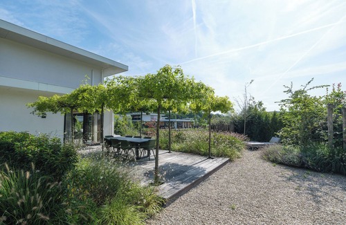 Zeewolde House | Luxury 6-person villa with private infrared sauna, outdoor shower, balcony with water views and sunny fenced garden with private dock. Located at Villa Resort Harderwold.