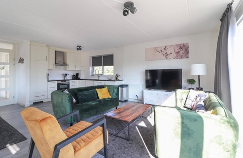 Makkum Cabin | Luxury 8-person fishing villa with a sauna, patio above the water, and private jetty at Beach Resort Makkum on the IJsselmeer.