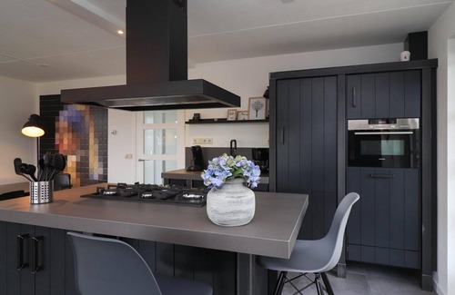 Makkum Cabin | Luxury 8-person fishing villa with a sauna, patio above the water, and private jetty at Beach Resort Makkum on the IJsselmeer.