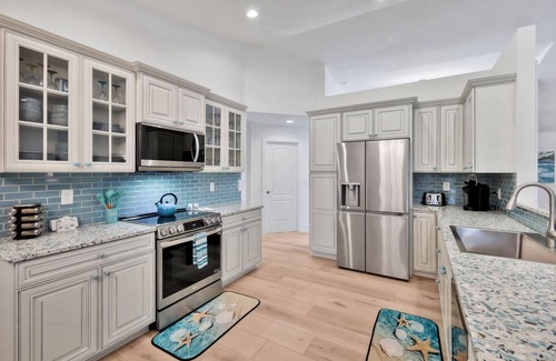 Pelican House | Luxury Gulf Access Pool Home With Large Tiki Hut Close to Tarpon Point Marina