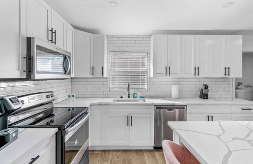 Sun Bay South House | Manhattan- A clean, modern 4-bedroom home in the heart of South Tampa. Sleeps up to 10, with a fenced backyard, BBQ grill, and firepit. Great for families, groups, or work stays. Minutes to Picnic Island Park, downtown Tampa, and the beaches.n