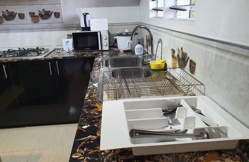 Suva Apartment | Master Bedroom with Shared Kitchen
