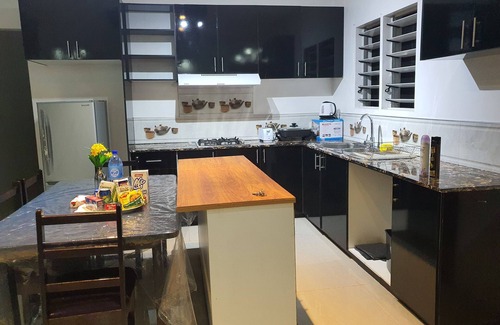 Suva Apartment | Master Bedroom with Shared Kitchen