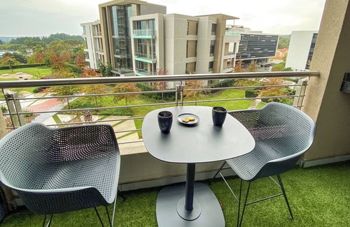 Menlyn Apartment | Menlyn Maine Residence King sized bed with patio - Paris
