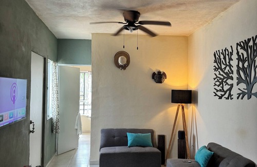 Cancun House | MiniHouse in front of park with parking.