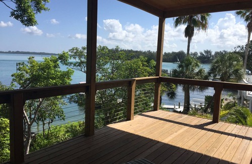 Longbeach Village House | Modern Bayfront Retreat with boat dock and short walk to Beach