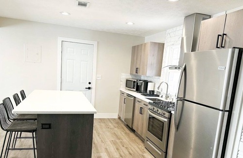 Lincoln House | Modern Home near downtown and UNL with Firepit, BBQ Grill & Air Hockey!