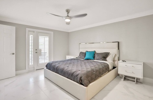 Palm River Estates House | Modern home with a pool, patio, hot tub, grill, washer/dryer, and central AC