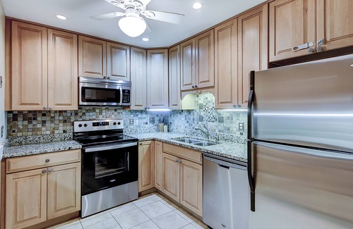 West Beach Condo | Modern, one-level condo near beach & golf with deck, sunroom, & pool