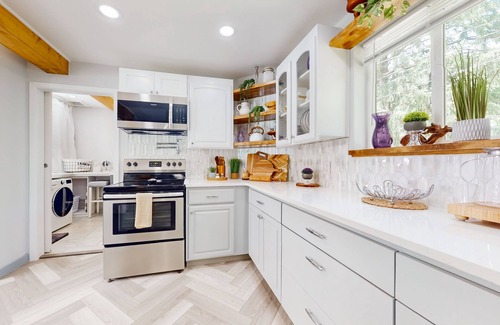 Gold Bar House | Modern riverfront home with hot tub, gas grill and patio