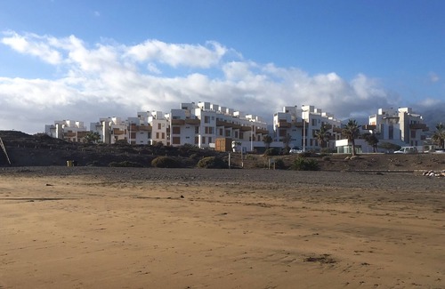 El Medano Apartment | Modern two floor apartment right by the beach with pool, patio and paddle court